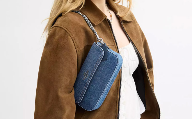 A Person with a Coach Outlet Denim Flap Bag