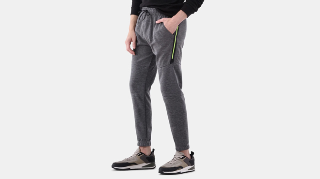 A person wearing a Burnside Mens Fleece Joggers in heather grey color