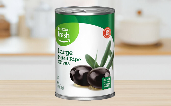 Amazon Fresh Large Pitted Ripe Olives 6 Ounce Can on a Table