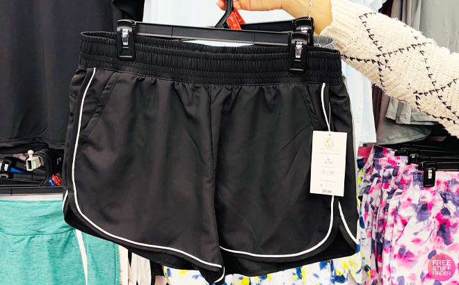 a Person Holding Black Athletic Works Womens and Womens Plus Piped Running Shorts