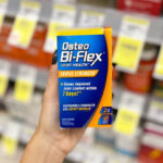 a Person Holding Osteo Bi Flex 80 Count Health Supplement