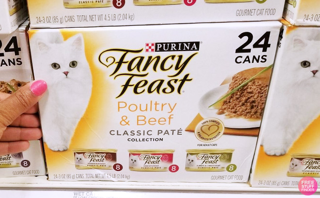 a Person Touching Purina Fancy Feast Poultry and Beef Grain Free Wet Cat Food Variety Pack