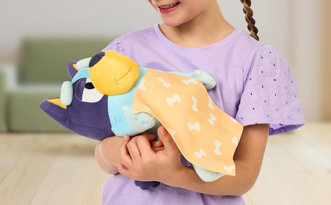 A Child Playing with a Bluey Plush A Child Playing with a Bluey Plush