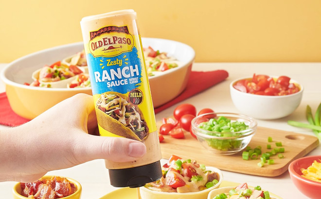 A Person Holding Old El Paso Zesty Ranch Taco Sauce