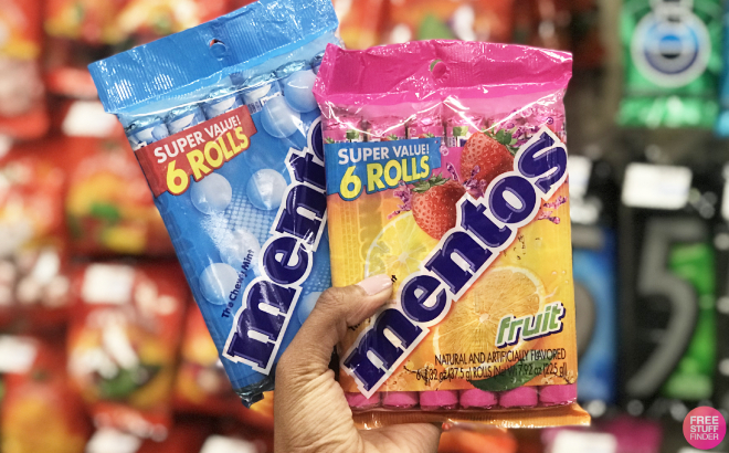 A Person Holding Packs of Mentos Chewy Candy Mint Roll