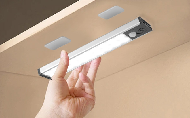 A Person Holding Under Cabinet Lighting