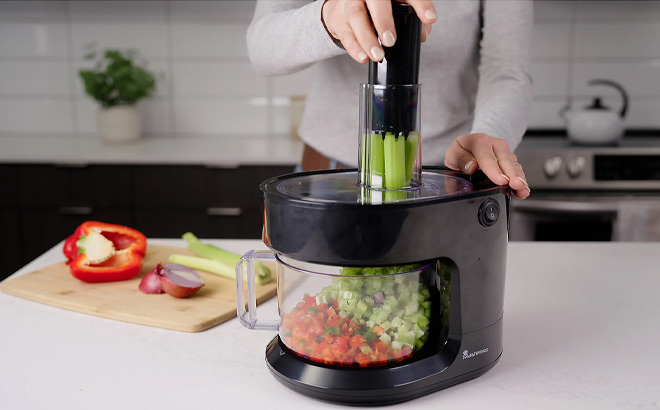 A Person Using MasterPro Electric Food Shredder A Person Using MasterPro Electric Food Shredder