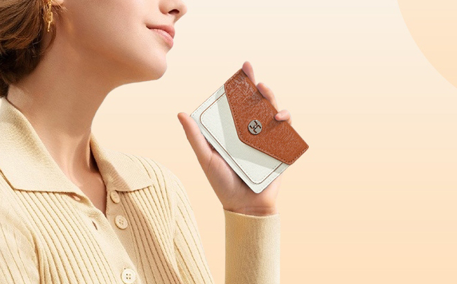 A Person holding a Telena Womens Small RFID Wallet in Beige Brown Color
