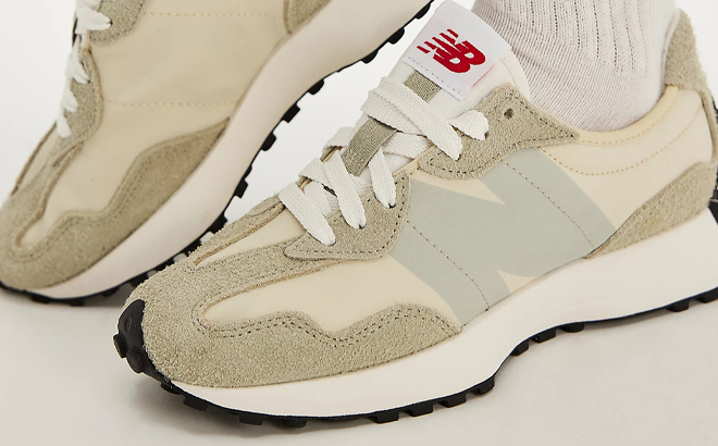 A Person wearing New Balance 327 Womens Shoes in Olivine Pale Moss Color
