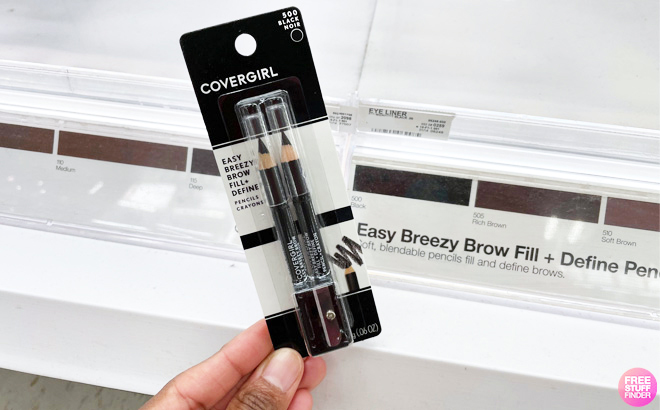 A person holding a CoverGirls Brow Pencil