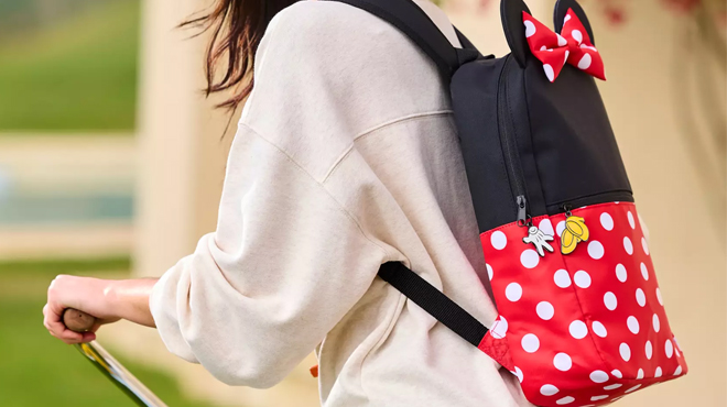 A person wearing a Minnie Mouse Costume Backpack