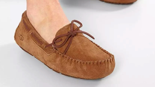 A person wearing a UGG Dakota Womens Moccasin Slippers