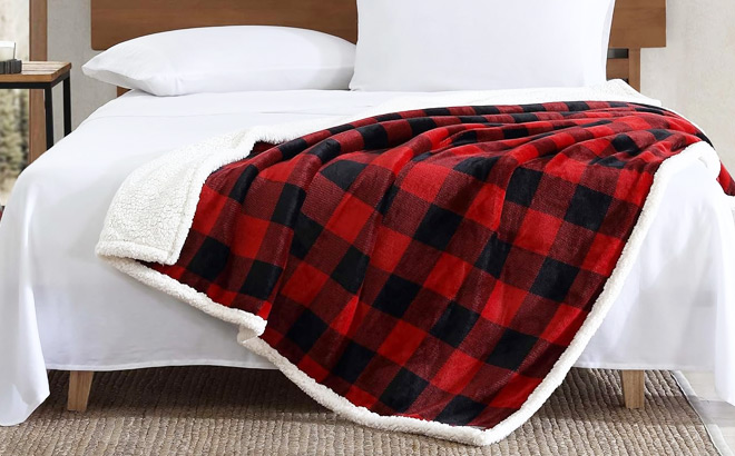 Eddie Bauer Reversible Sherpa Throw Blanket on a Bed