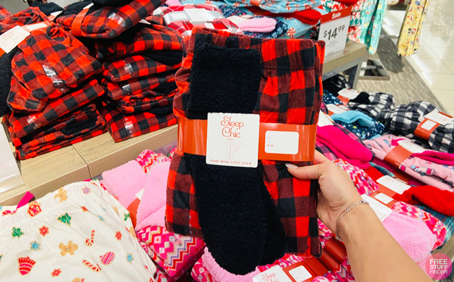 Person Holding Pajama Pants with Socks in JCPenney Store