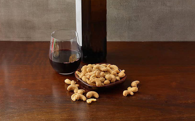 Planters Cashews and a Glass of Wine on a Table Planters Cashews and a Glass of Wine on a Table