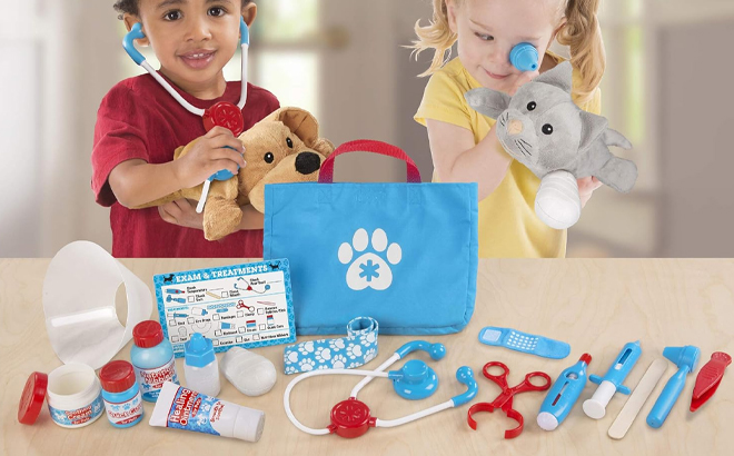 Two Kids Playing with the Melissa & Doug Examine and Treat Pet Vet Play Set