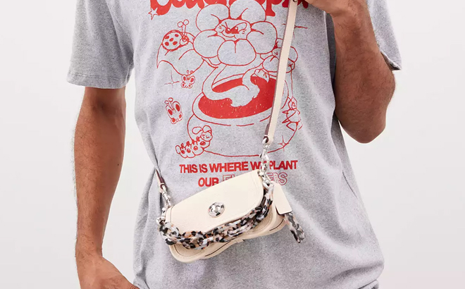 A Man Wearing Coach Outlet Mini Wavy Dinky Bag In Coachtopia Leather