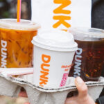 A Person Carrying a Dunkin Drinks Takeout