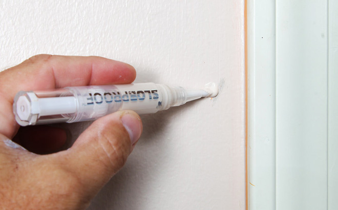 A Person Using a Slobproof Refillable Touch Up Paint Pen