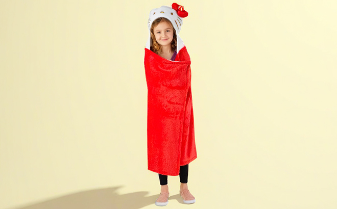A girl wearing a Hello Kitty Kids Hooded Throws 2 pk