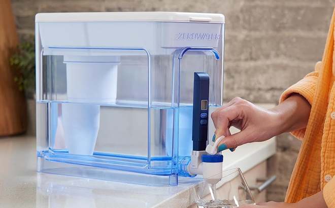 A person using a ZeroWater 32 Cup Water Filter Pitcher Dispenser