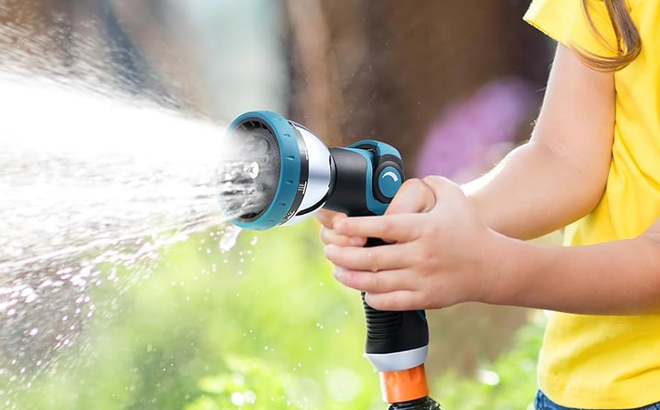Hands holding Clothirily Garden Hose Sprayer Nozzle