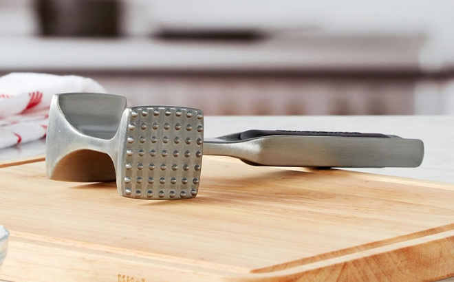 KitchenAid Gourmet Meat Tenderizer on top of a chopping board