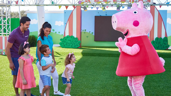 People interacting with Peppa Pig Mascot