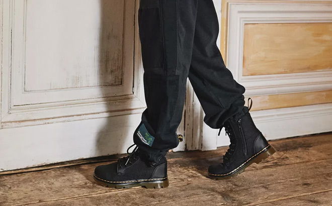 A Child Wearing Dr Martens Junior Combs Casual Boots in Black