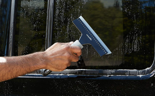A Man Using Amazon Basics Window Squeegee