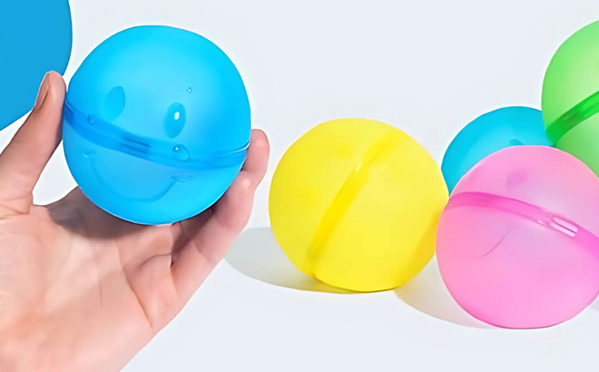 A Person Holding a Hydroburst Reusable Water Balloon wih a Happy Face Design
