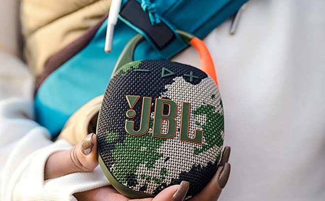 A Person Holding a JBL Clip 5 Speaker