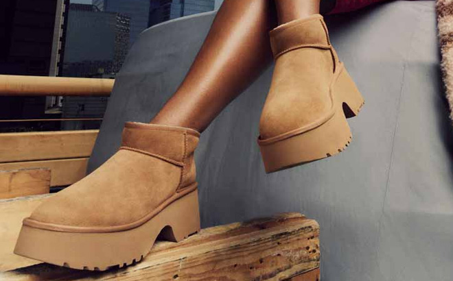A Person Wearing UGG Womens Classic Ultra Mini New Heights Platform Boots