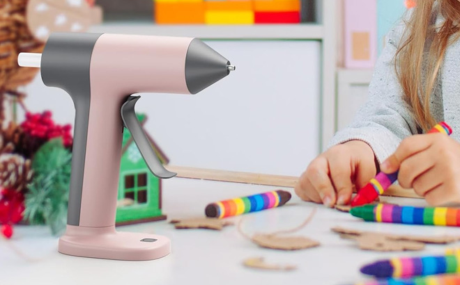 Tilswall Cordless Hot Glue Gun in Pink Color on the Table Tilswall Cordless Hot Glue Gun in Pink Color on the Table
