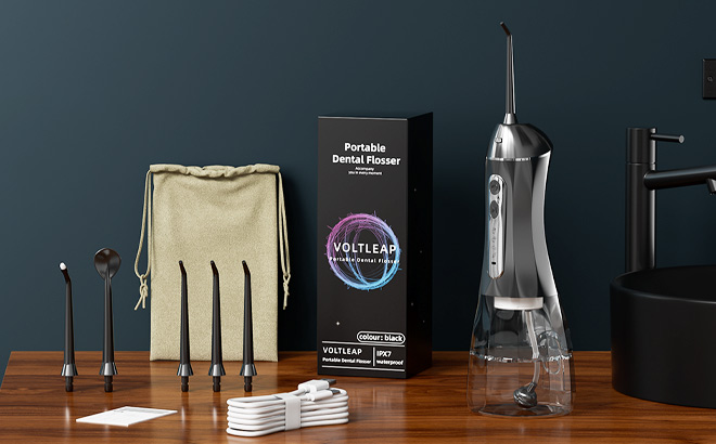 Water Flosser with Travel Bag and 4 Tips on the Table Water Flosser with Travel Bag and 4 Tips on the Table