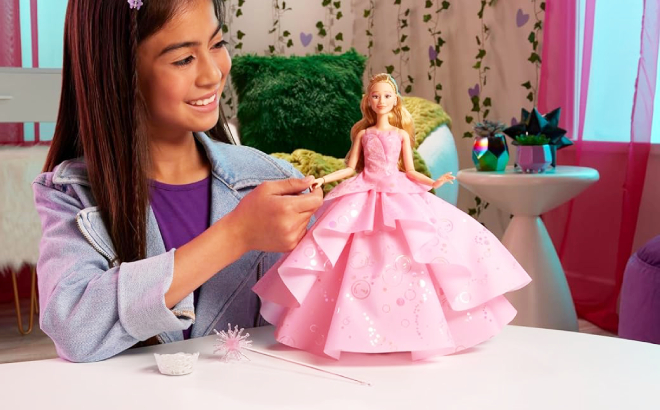 A Girl Playing with Wicked Deluxe Glinda Fashion Doll A Girl Playing with Wicked Deluxe Glinda Fashion Doll