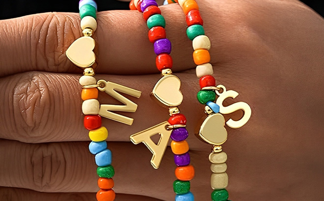 A Person Holding Colorful Initial Necklaces