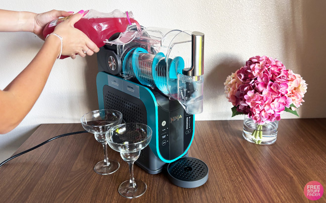 A Person Sipping Liquid into Slushie Machine