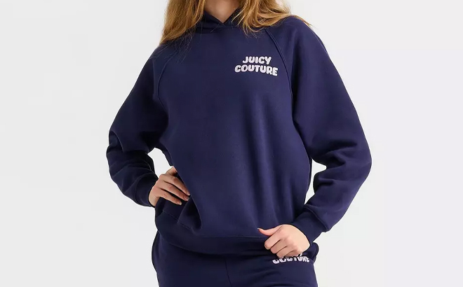 A Person Wearing the Womens Juicy Couture Wave Fleece Hoodie in Navy