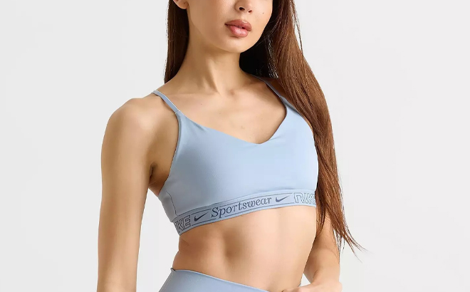 A Person wearing Nike Womens Indy Light Support Sports Bra