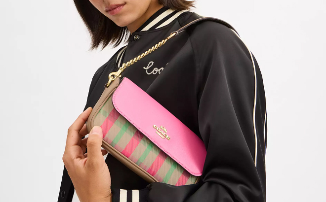 A Woman Holding Coach Outlet Hailey Flap Bag with Plaid Print A Woman Holding Coach Outlet Hailey Flap Bag with Plaid Print