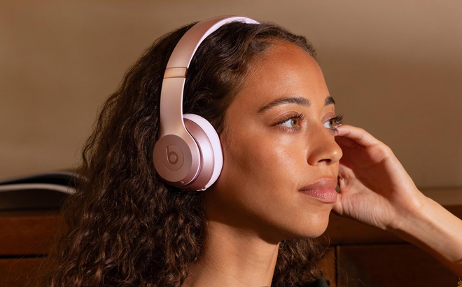 A Woman Wearing Beats Solo 4 Wireless Bluetooth On Ear Headphonesa