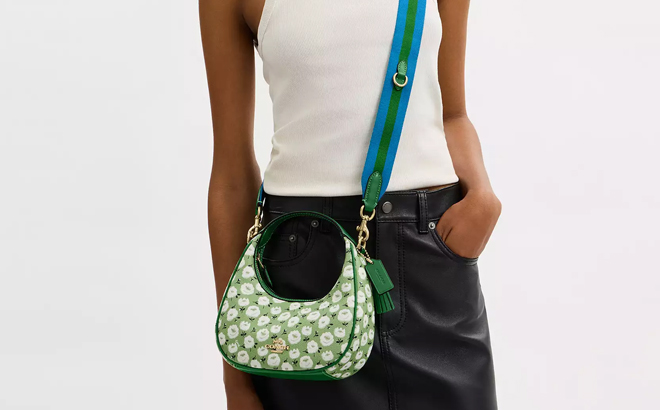 A Woman Wearing Coach Outlet Carmen Mini Crossbody Bag With Floral Print A Woman Wearing Coach Outlet Carmen Mini Crossbody Bag With Floral Print