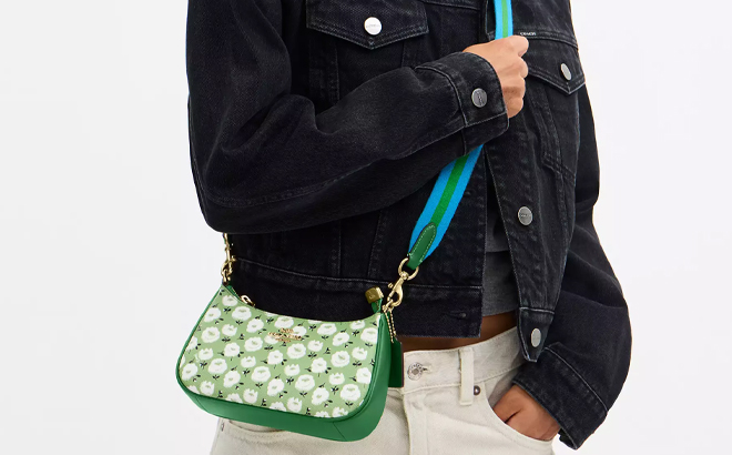 A Woman Wearing Coach Outlet Teri Mini Crossbody Bag with Floral Print A Woman Wearing Coach Outlet Teri Mini Crossbody Bag with Floral Print