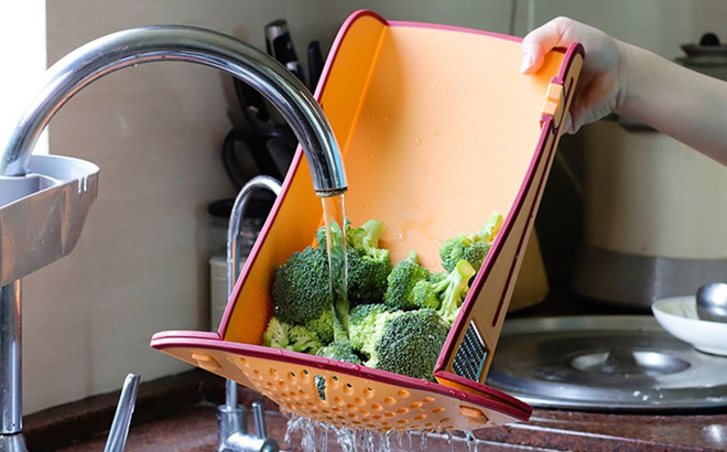 A Person Holding 6 in 1 Multi functional Folding Cutting Board