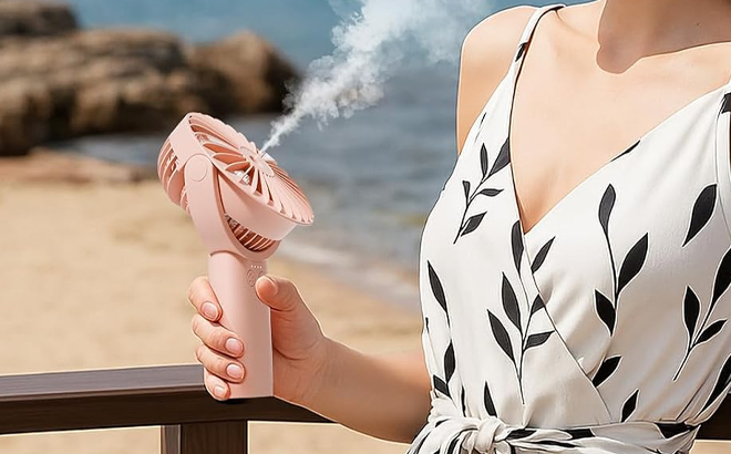 A Person Using the HonHey Handheld Misting Fan A Person Using the HonHey Handheld Misting Fan