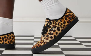 A Person wearing Vans Authentic Lowpro Skate Shoes with Leopard Print