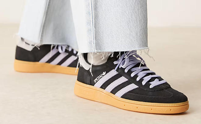 A Woman Wearing Adidas Originals Handball Spezial Sneakers in Black and Blue A Woman Wearing Adidas Originals Handball Spezial Sneakers in Black and Blue