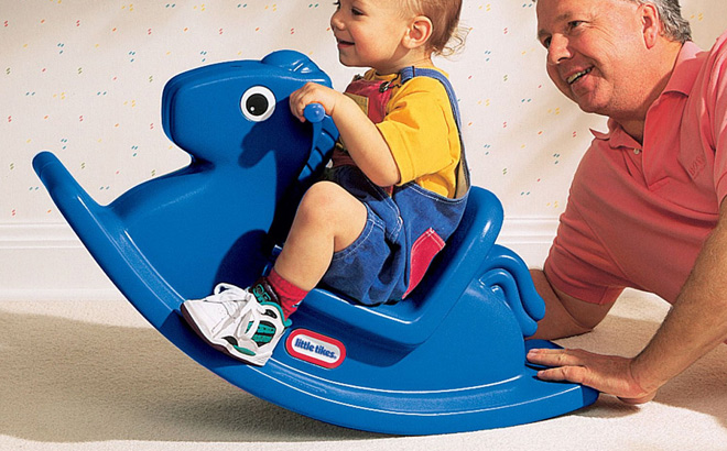 A Child Riding a Little Tikes Rocking Horse in Blue
