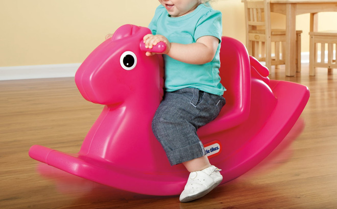 A Child Riding a Little Tikes Rocking Horse